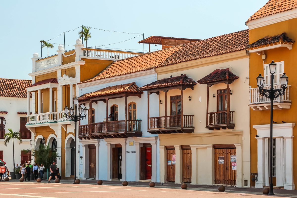 Colorful colonial buildings with wooden balconies on Plaza de la Aduana in Cartagena's walled city