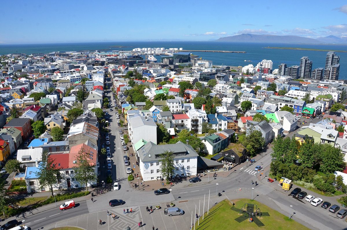 Colorful rooftops of central Reykjavík seen from Hallgrímskirkja, with Faxaflói bay beyond